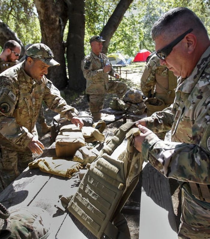 Image of California Minutemen packing their gear outside on picnic tables